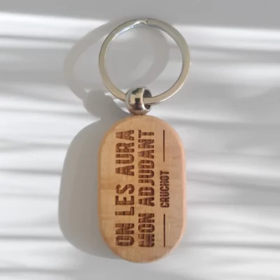 Porte‑clé personnalisé citation culte Les Gendarmes à Saint‑Tropez Porte‑clé bois gravé “On les aura mon adjudant Cruchot” personnalisable en ligne